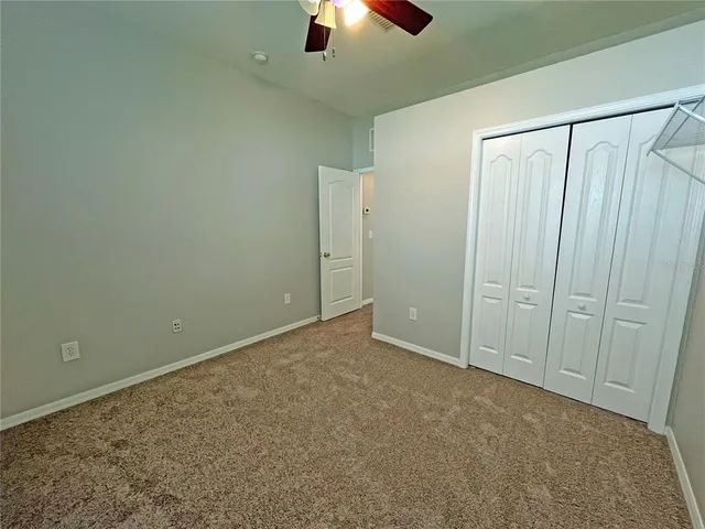 an empty room with closet area