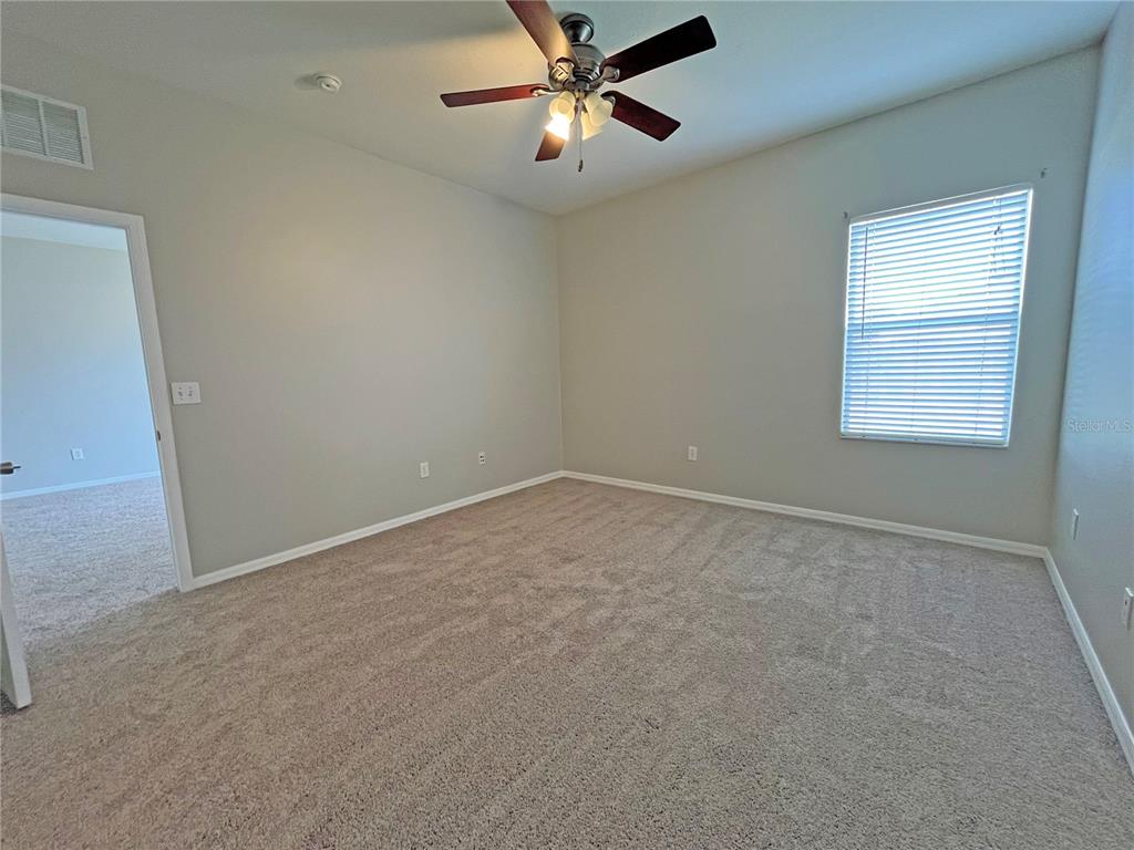 24925 Vintage Court Lutz, FL 33559 - Photo 30 of 38 an empty room with a window and a fan