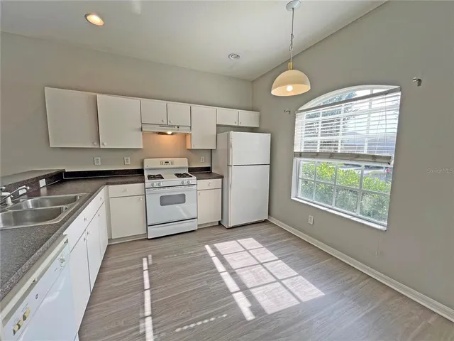 a kitchen with a white cabinets and white appliances