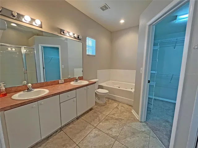 a bathroom with a bathtub and toilet