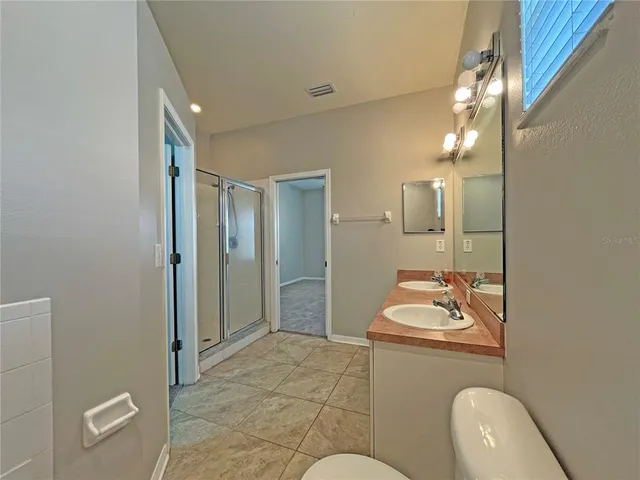 a bathroom with a glass shower door