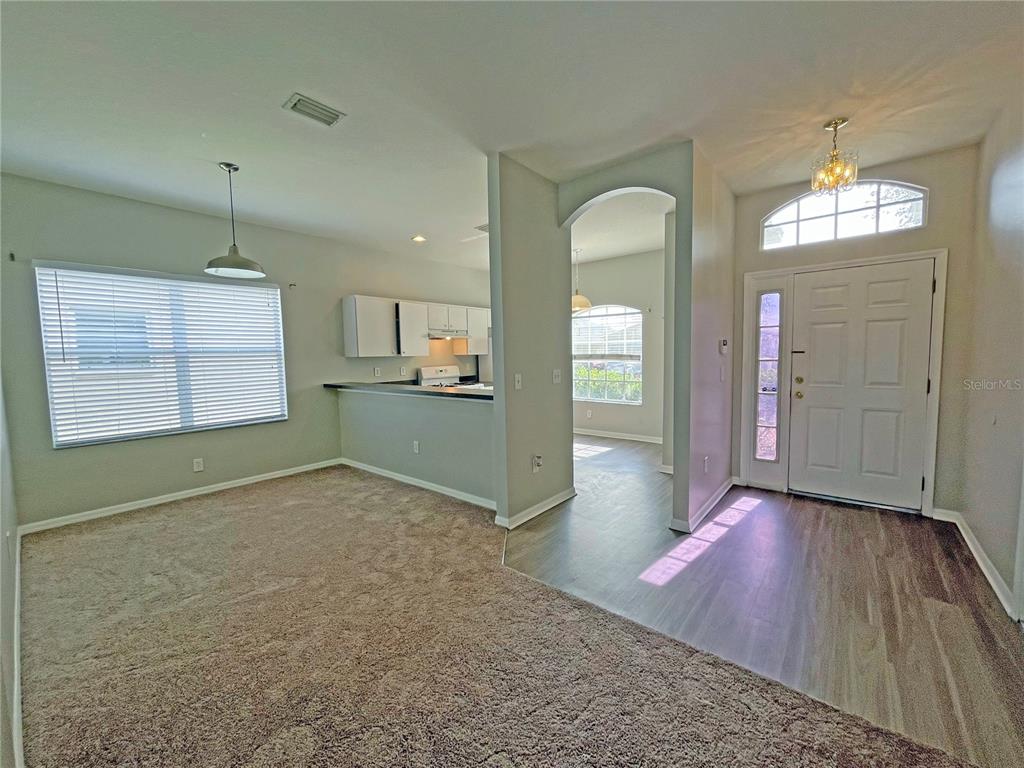 24925 Vintage Court Lutz, FL 33559 - Photo 10 of 38 wooden floor in an empty room with a window