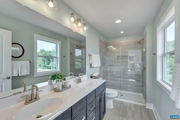 a bathroom with double vanity sink and a mirror