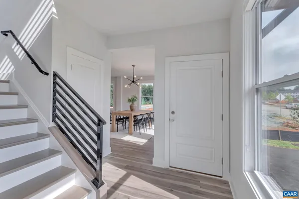 a view of entryway and hall with wooden floor
