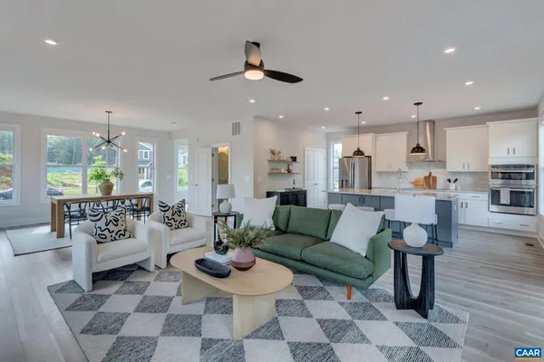 a living room with furniture and view of kitchen