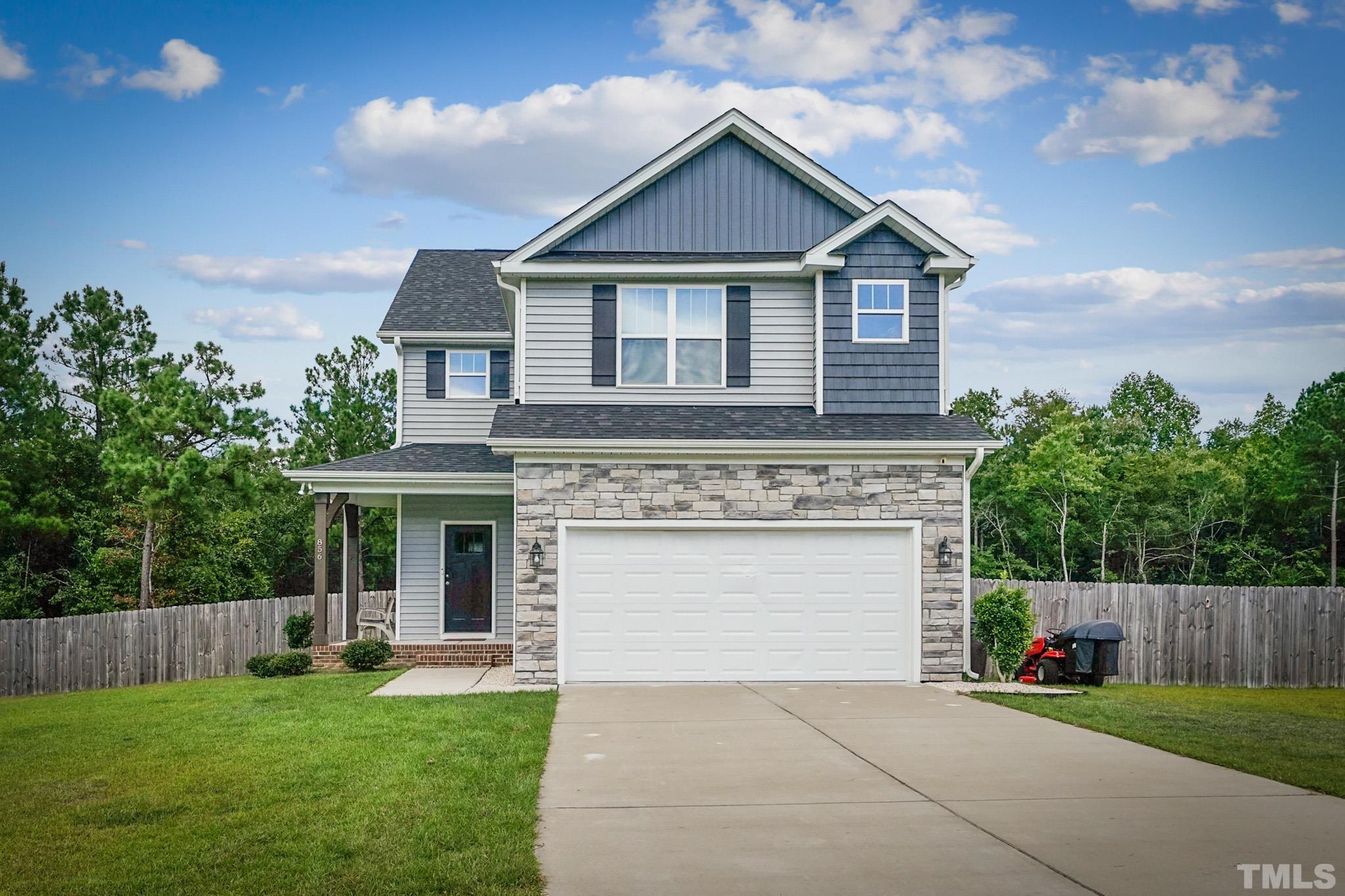 856 Juno Drive Broadway, NC 27505 - Photo 1 of 46 a front view of a house with a yard and garage