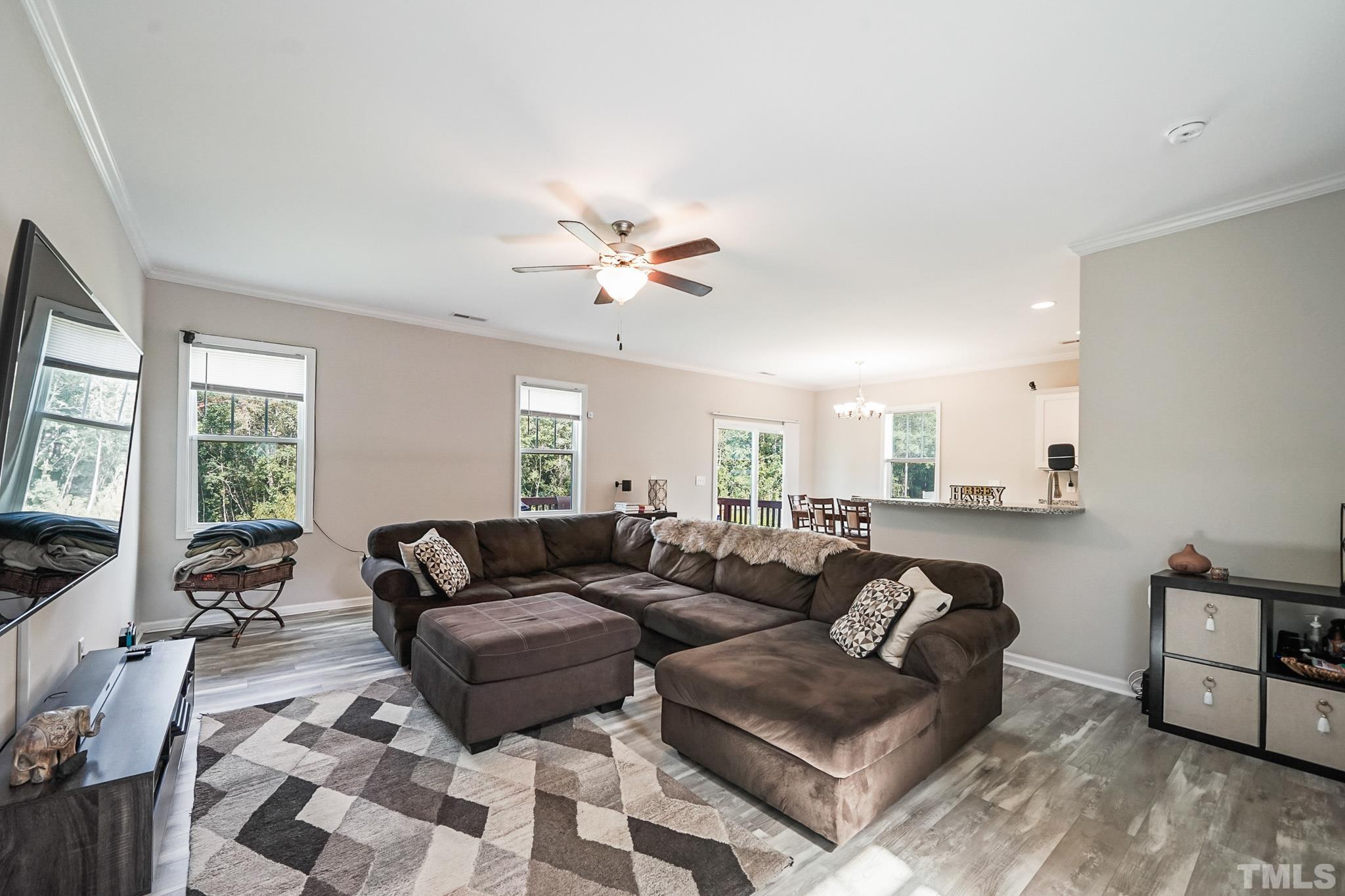 856 Juno Drive Broadway, NC 27505 - Photo 14 of 46 a living room with furniture ceiling fan and a window