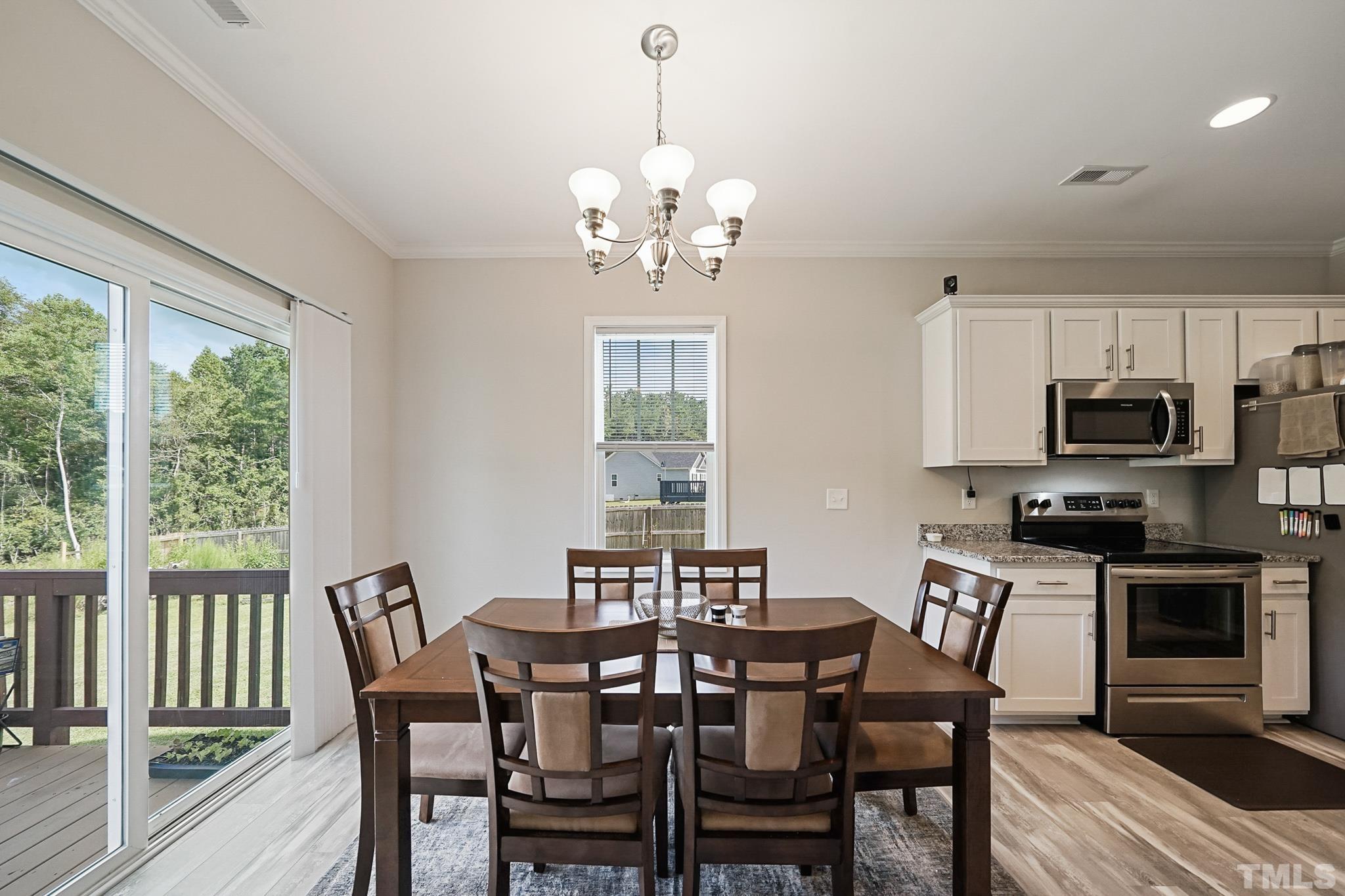 856 Juno Drive Broadway, NC 27505 - Photo 16 of 46 a view of a dining room with furniture window and wooden floor