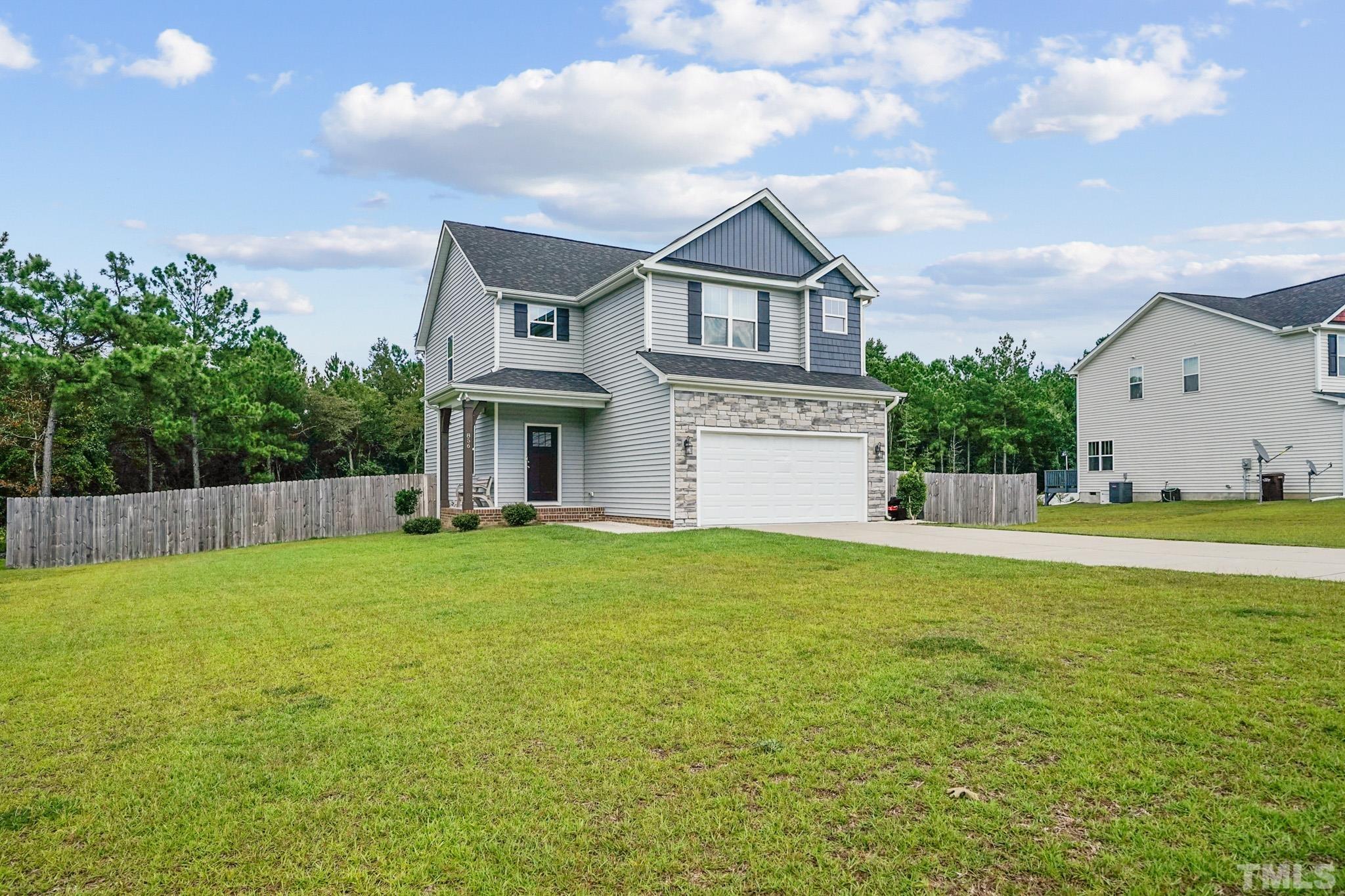 856 Juno Drive Broadway, NC 27505 - Photo 2 of 46 a front view of a house with garden