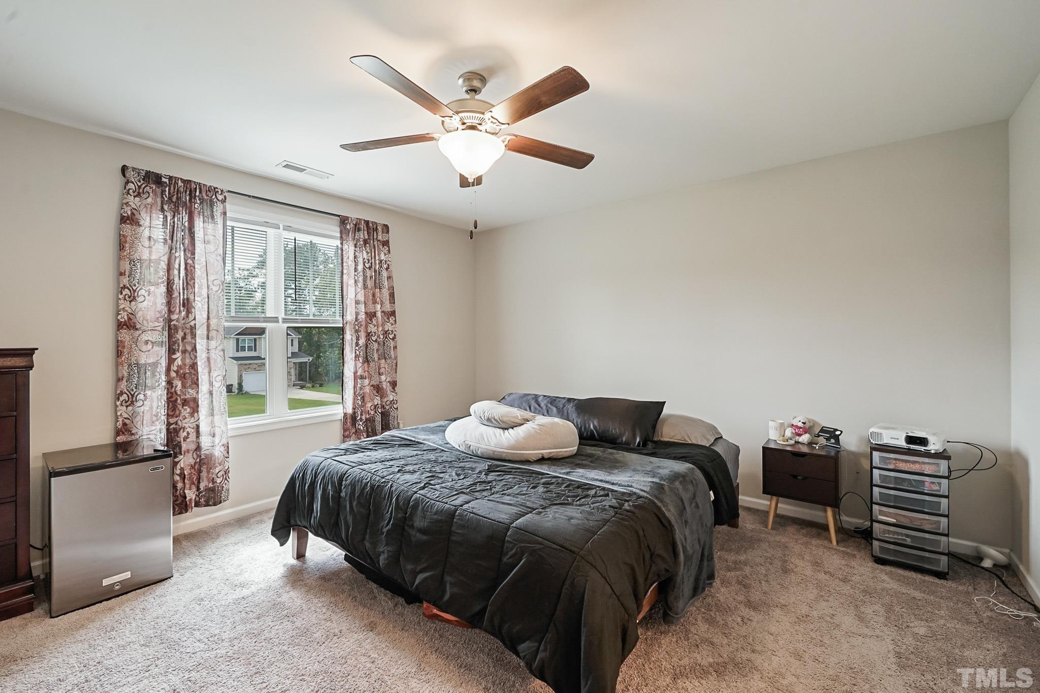 856 Juno Drive Broadway, NC 27505 - Photo 26 of 46 a bedroom with a bed and a large window