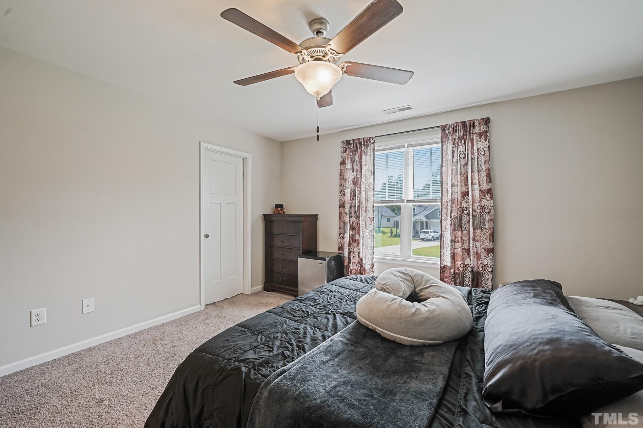 856 Juno Drive Broadway, NC 27505 - Photo 27 of 46 a bedroom with a bed and a large window
