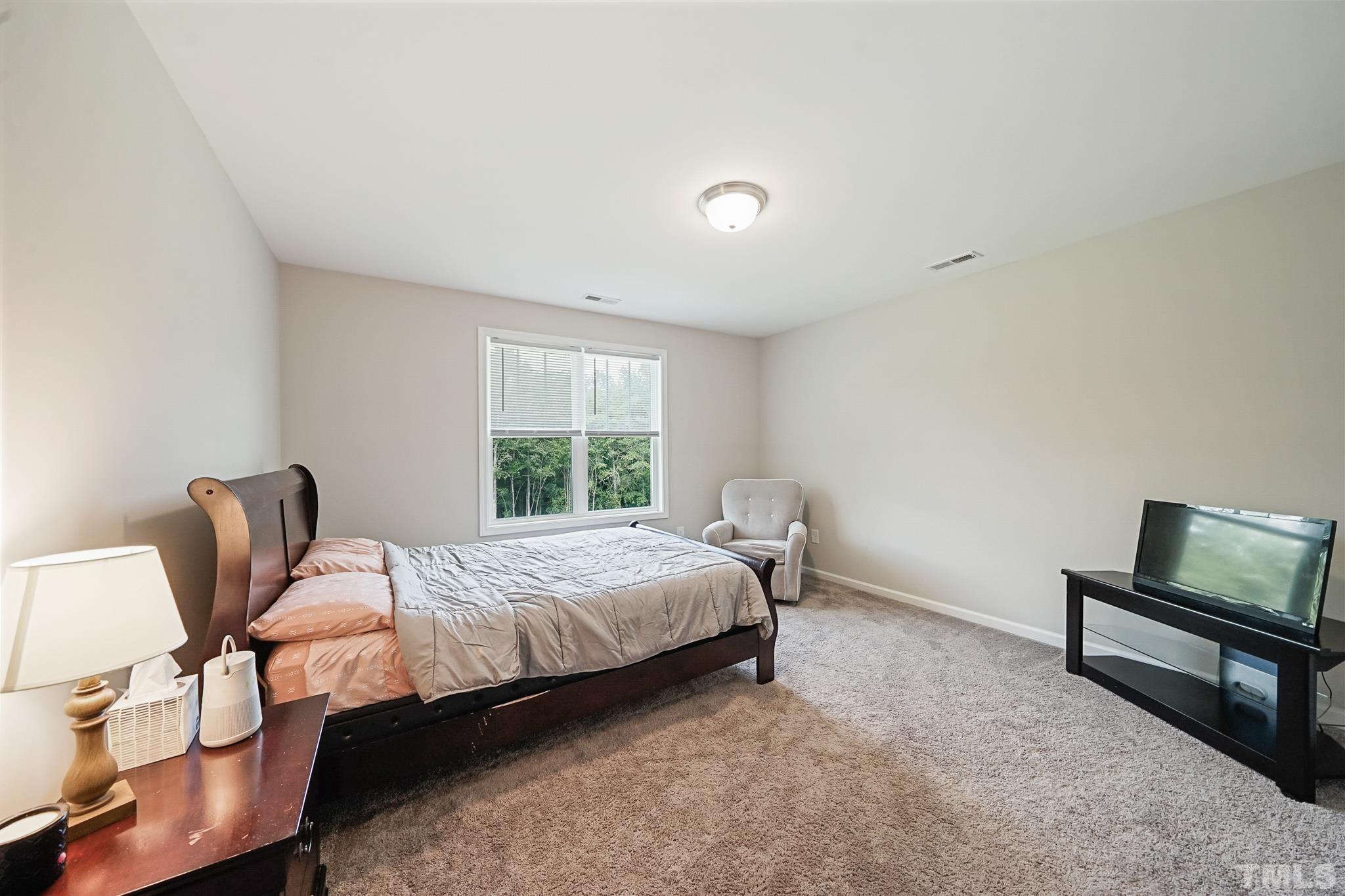 856 Juno Drive Broadway, NC 27505 - Photo 33 of 46 a bedroom with a bed chair and window