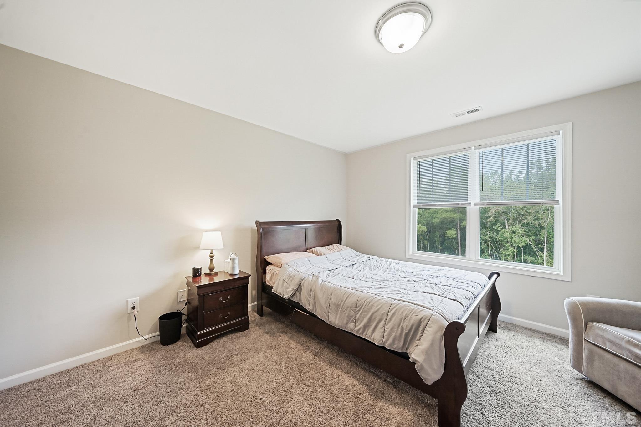 856 Juno Drive Broadway, NC 27505 - Photo 34 of 46 a bedroom with a bed and a couch