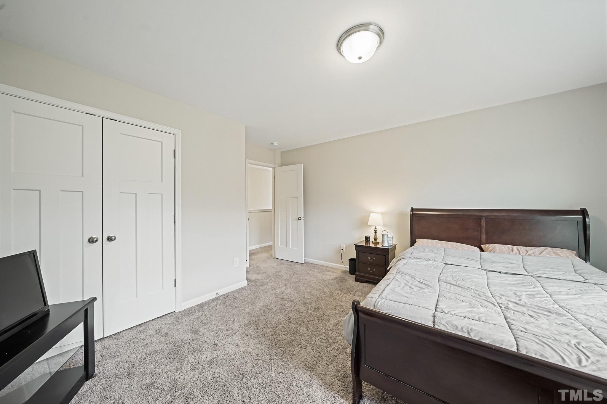 856 Juno Drive Broadway, NC 27505 - Photo 35 of 46 a bedroom with a bed and a tv