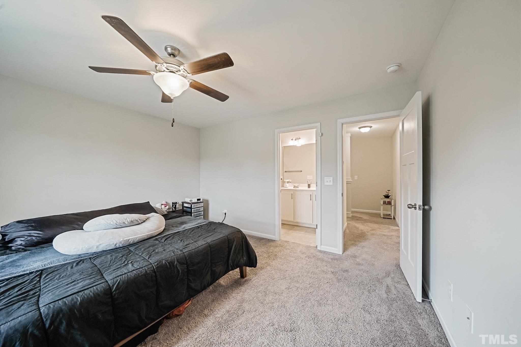 856 Juno Drive Broadway, NC 27505 - Photo 39 of 46 a spacious bedroom with a bed and a chandelier