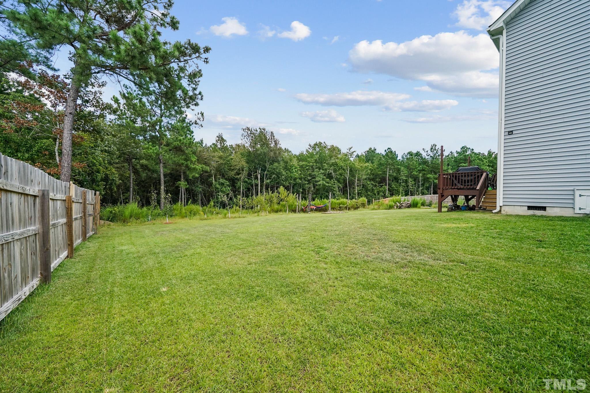 856 Juno Drive Broadway, NC 27505 - Photo 4 of 46 a view of a green field with wooden fence