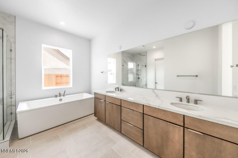 2400 Arrowroot Way, Unit CINNAMON 84 Sparks, NV 89441 - Photo 19 of 27 a bathroom with a tub sink and mirror