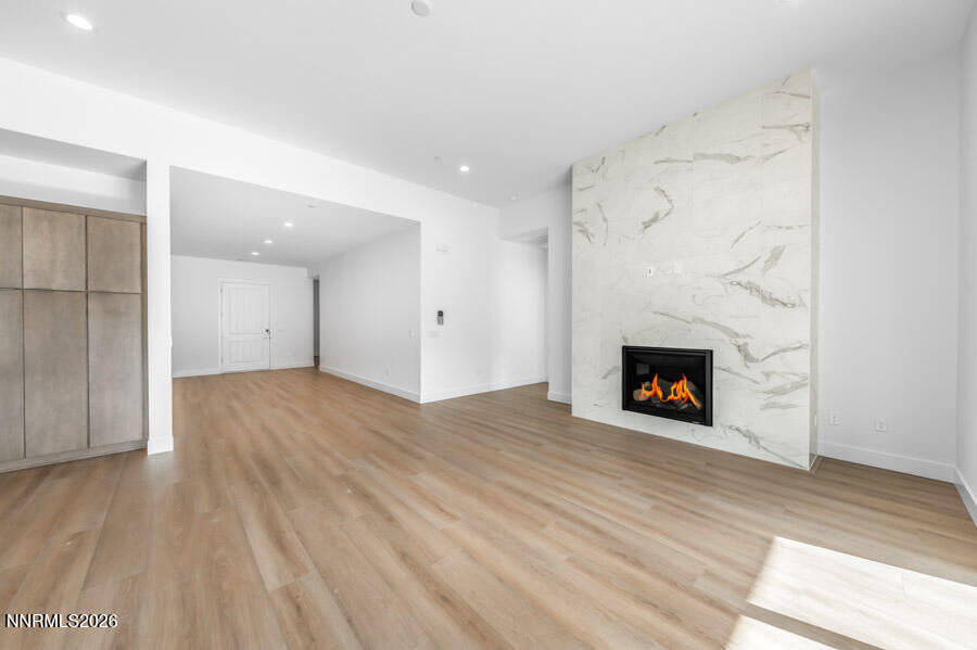2400 Arrowroot Way, Unit CINNAMON 84 Sparks, NV 89441 - Photo 9 of 27 a view of empty room with wooden floor and fireplace