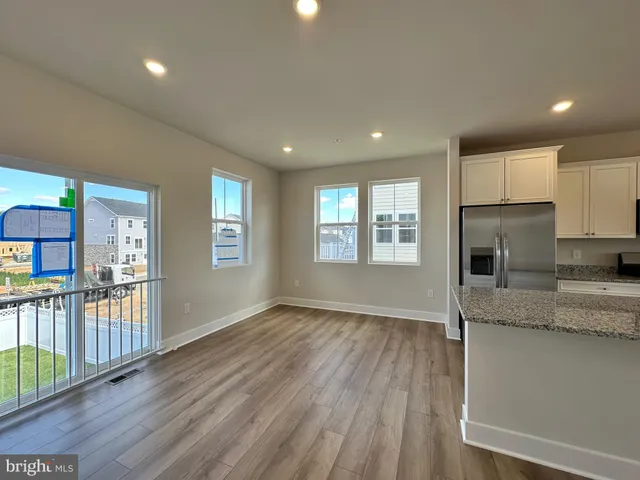 a view of a kitchen and entryway with wooden floor