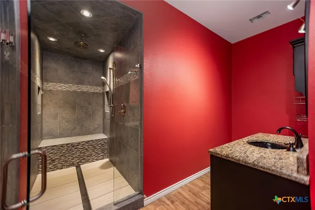 an empty room with a ceiling fan and carpet