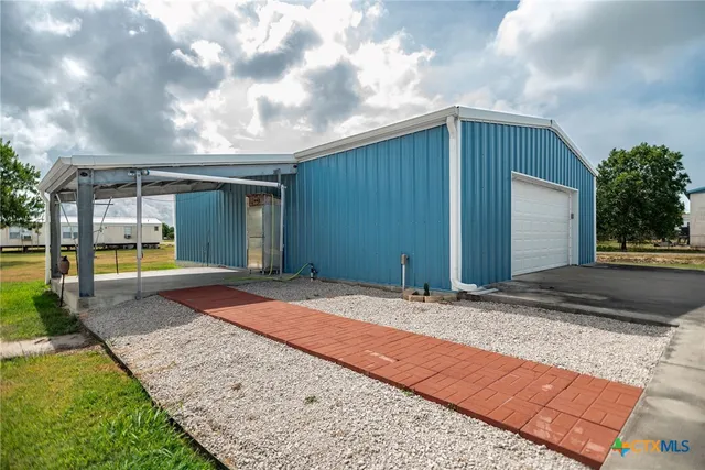a view of a house with backyard and sitting area