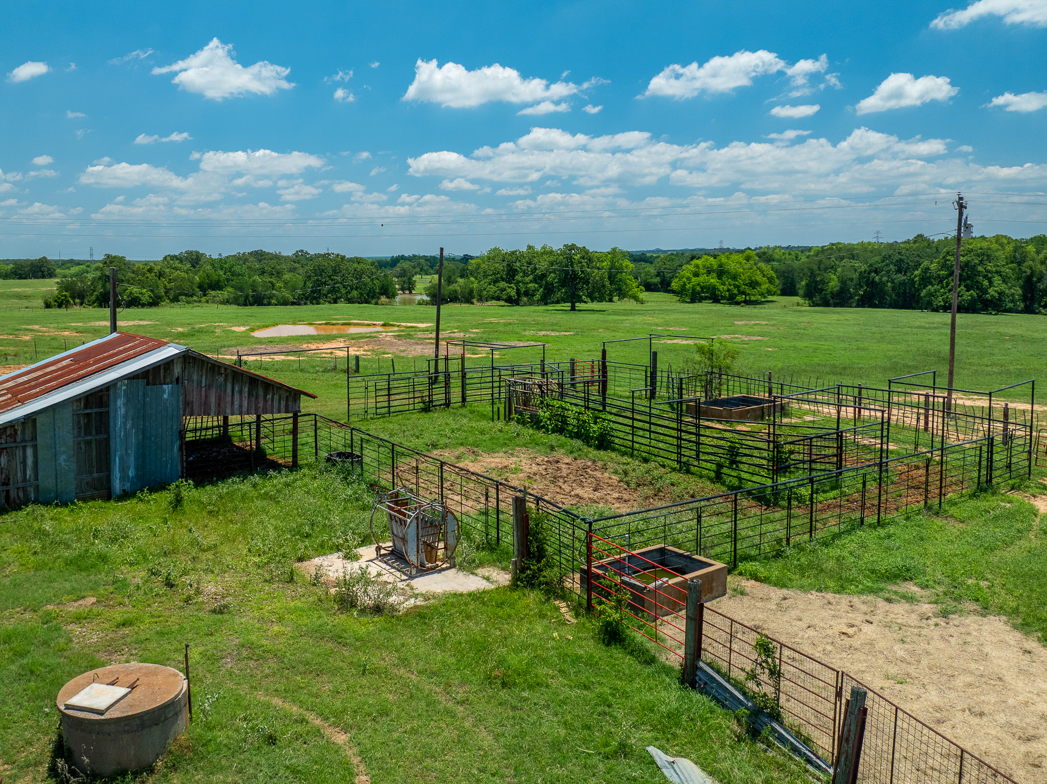 400 619th Spur Elgin, TX 78621 - Photo 38 of 40 A rural landscape showcases extensive pastures and a functional barn, ideal for agricultural pursuits.