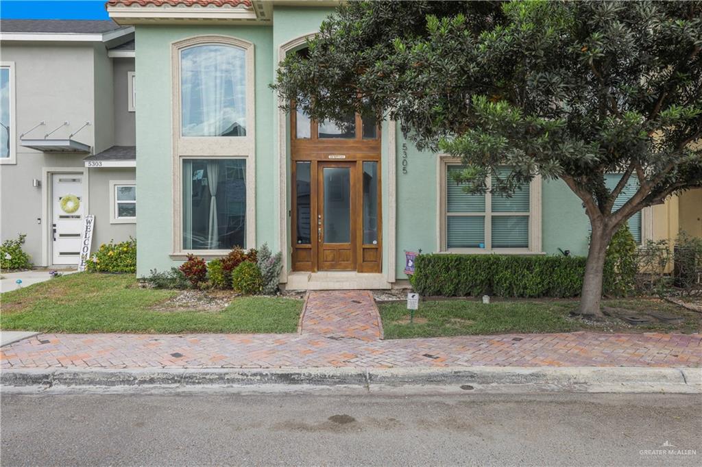 a front view of a house with garden