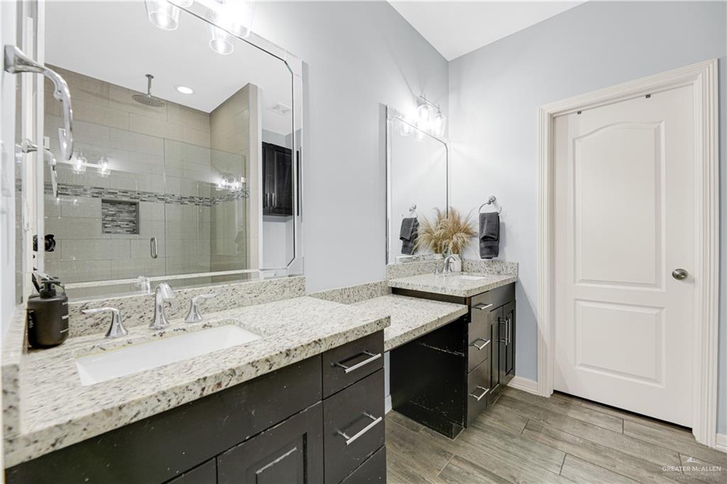 5305 North Crown Point Pharr, TX 78577 - Photo 12 of 24 a bathroom with a granite countertop sink and a mirror