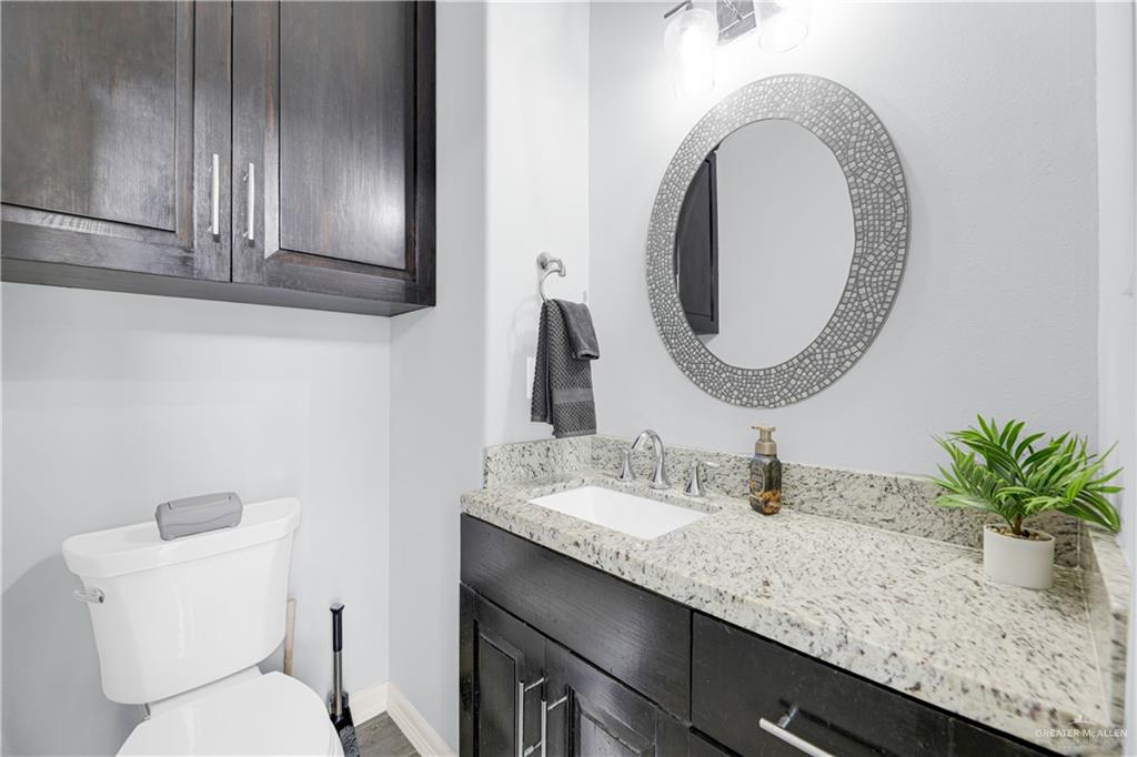 5305 North Crown Point Pharr, TX 78577 - Photo 13 of 24 a bathroom with a granite countertop sink and a mirror