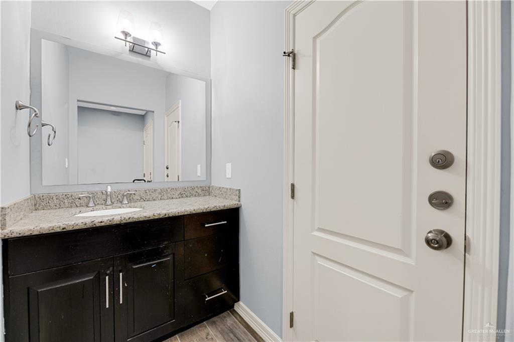 5305 North Crown Point Pharr, TX 78577 - Photo 18 of 24 a bathroom with a granite countertop sink and a mirror