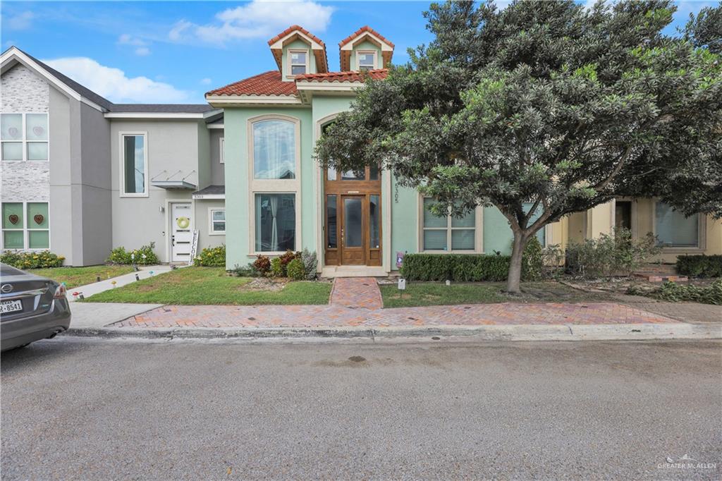 5305 North Crown Point Pharr, TX 78577 - Photo 3 of 24 a front view of a house with a garden and garage