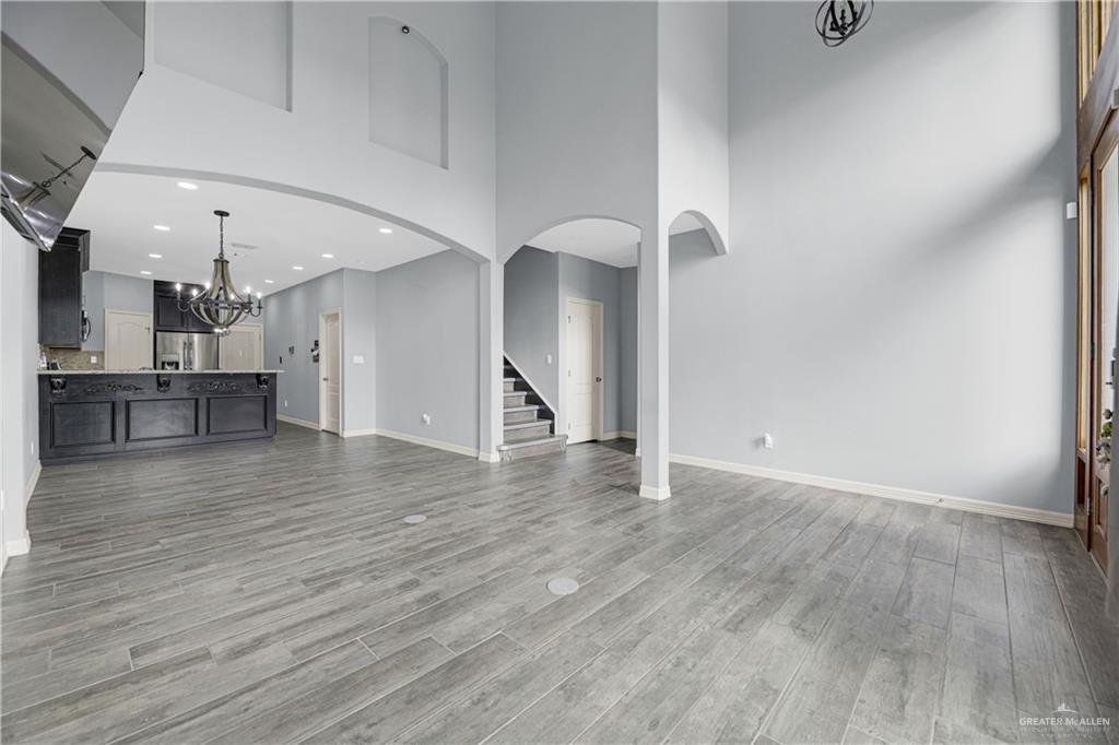 5305 North Crown Point Pharr, TX 78577 - Photo 4 of 24 a view of empty room with wooden floor and kitchen view