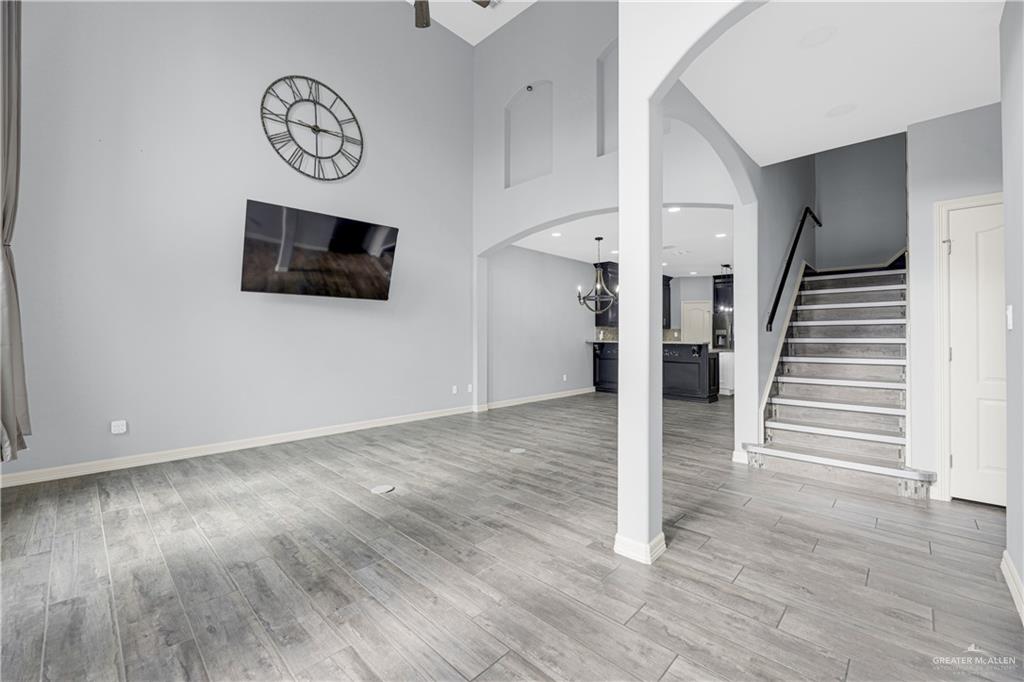 5305 North Crown Point Pharr, TX 78577 - Photo 5 of 24 a view of a livingroom with wooden floor and a flat screen tv