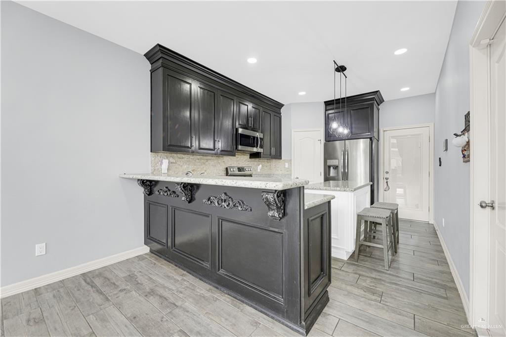5305 North Crown Point Pharr, TX 78577 - Photo 6 of 24 a kitchen with a sink cabinets and stainless steel appliances