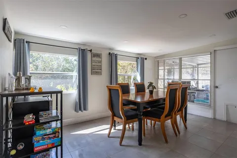 a dining room with furniture and window