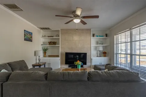 a living room with furniture and a fireplace