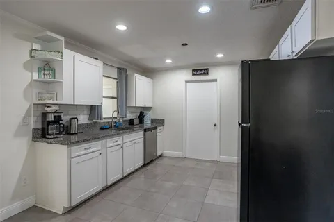 a kitchen with a sink stainless steel appliances and cabinets
