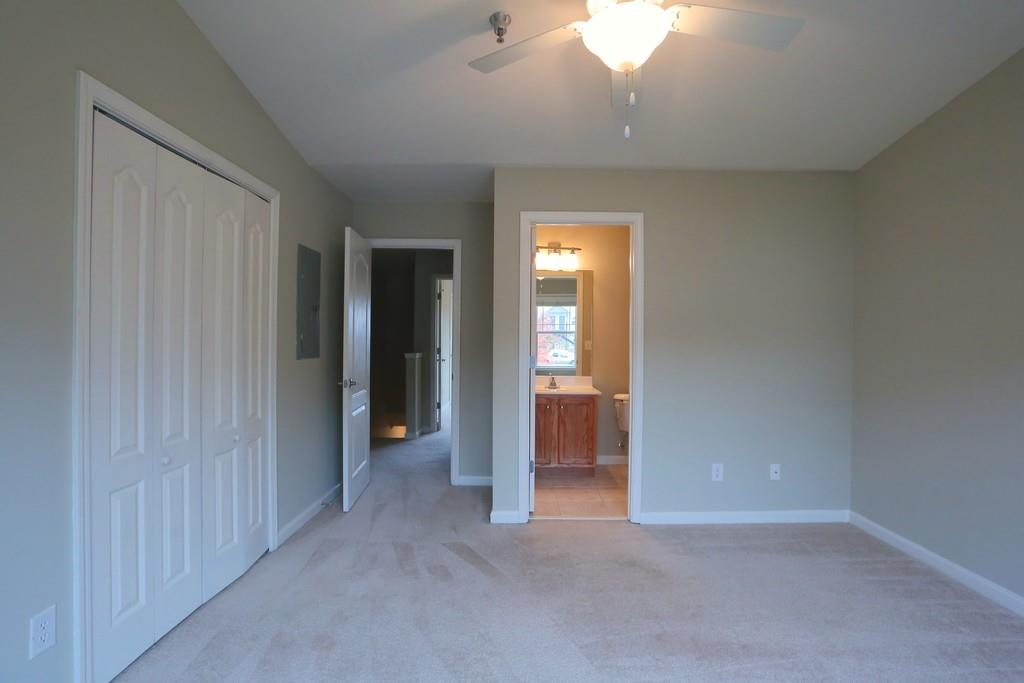 232 Epps Bridge Road, Unit 1A Athens, GA 30606 - Photo 10 of 14 an empty room with closet and a chandelier fan