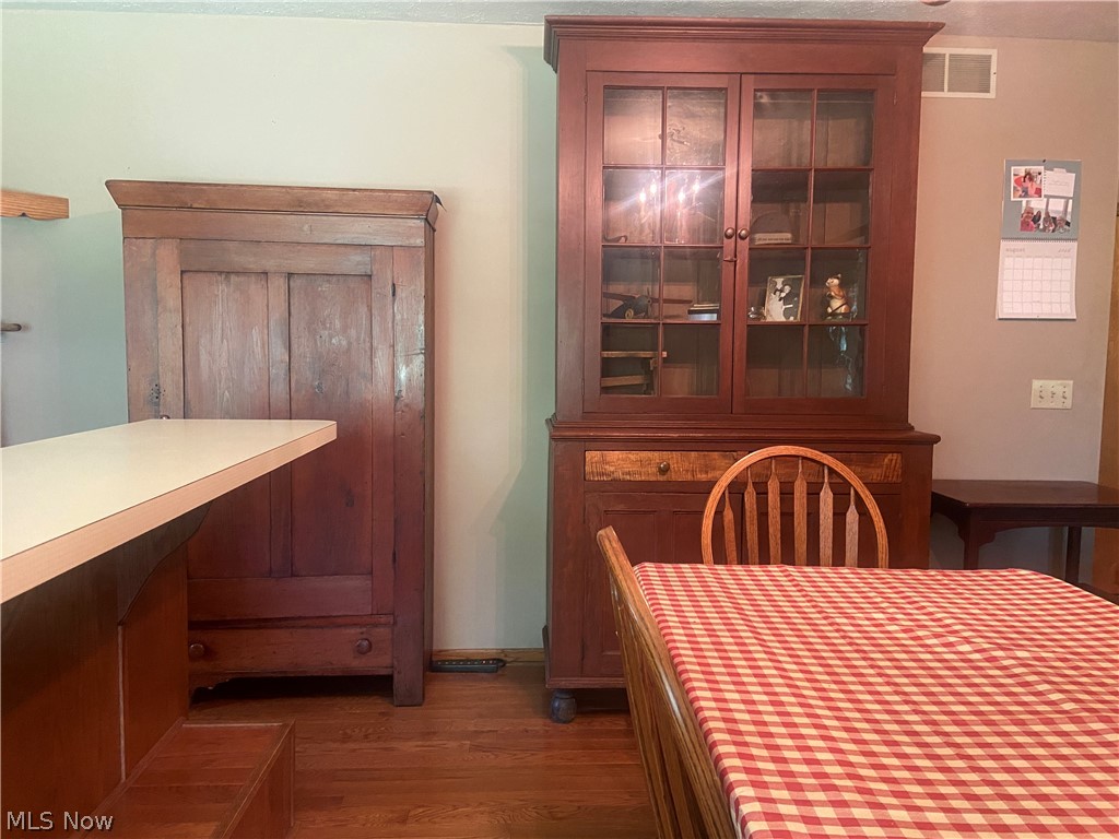 2445 South Elyria Road Wooster, OH 44691 - Photo 12 of 46 Dining area with dark wood-style flooring and baseboards