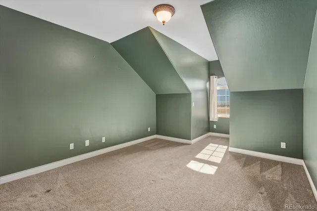 a view of an empty room with stairs and furniture