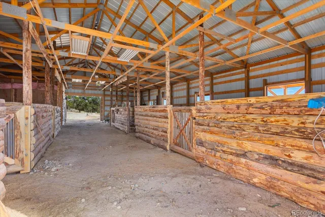 a living room with furniture and a ceiling fan
