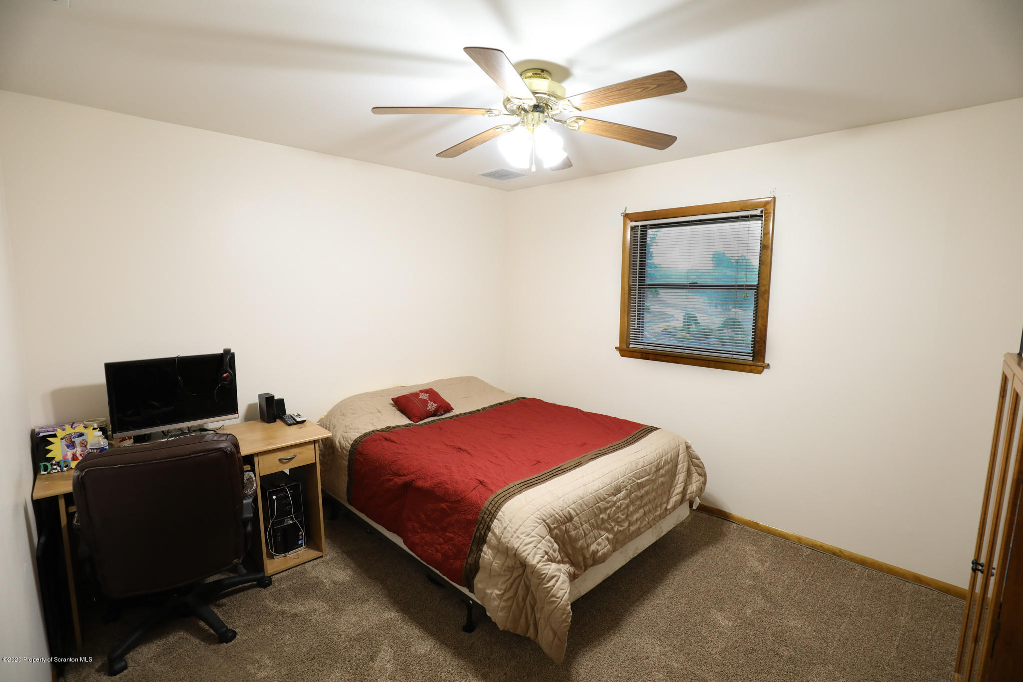3 Patrick Road Pittston, PA 18640 - Photo 12 of 16 a bedroom with a bed and a chandelier