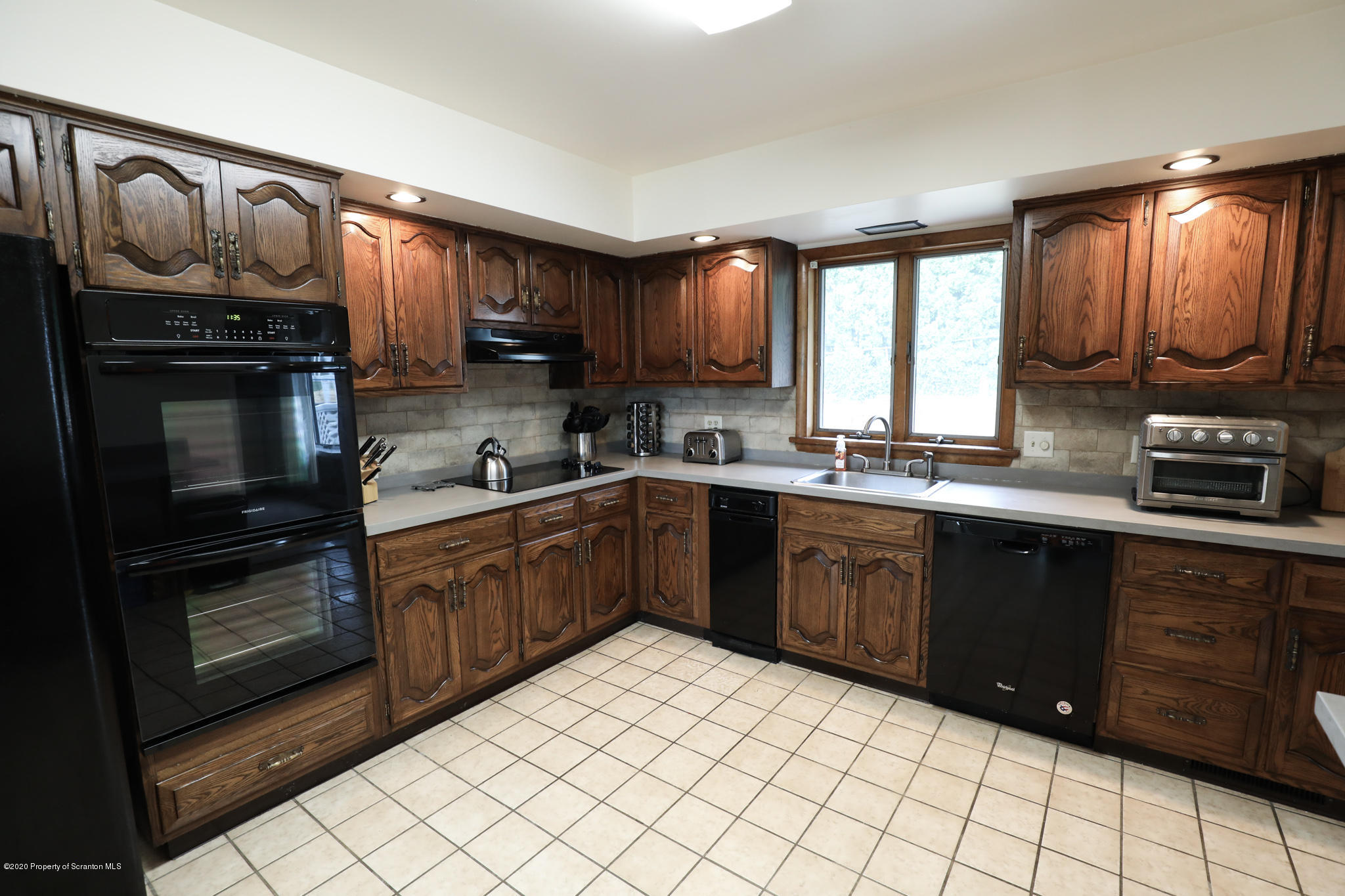 3 Patrick Road Pittston, PA 18640 - Photo 3 of 16 a kitchen with granite countertop cabinets stainless steel appliances a sink and a window
