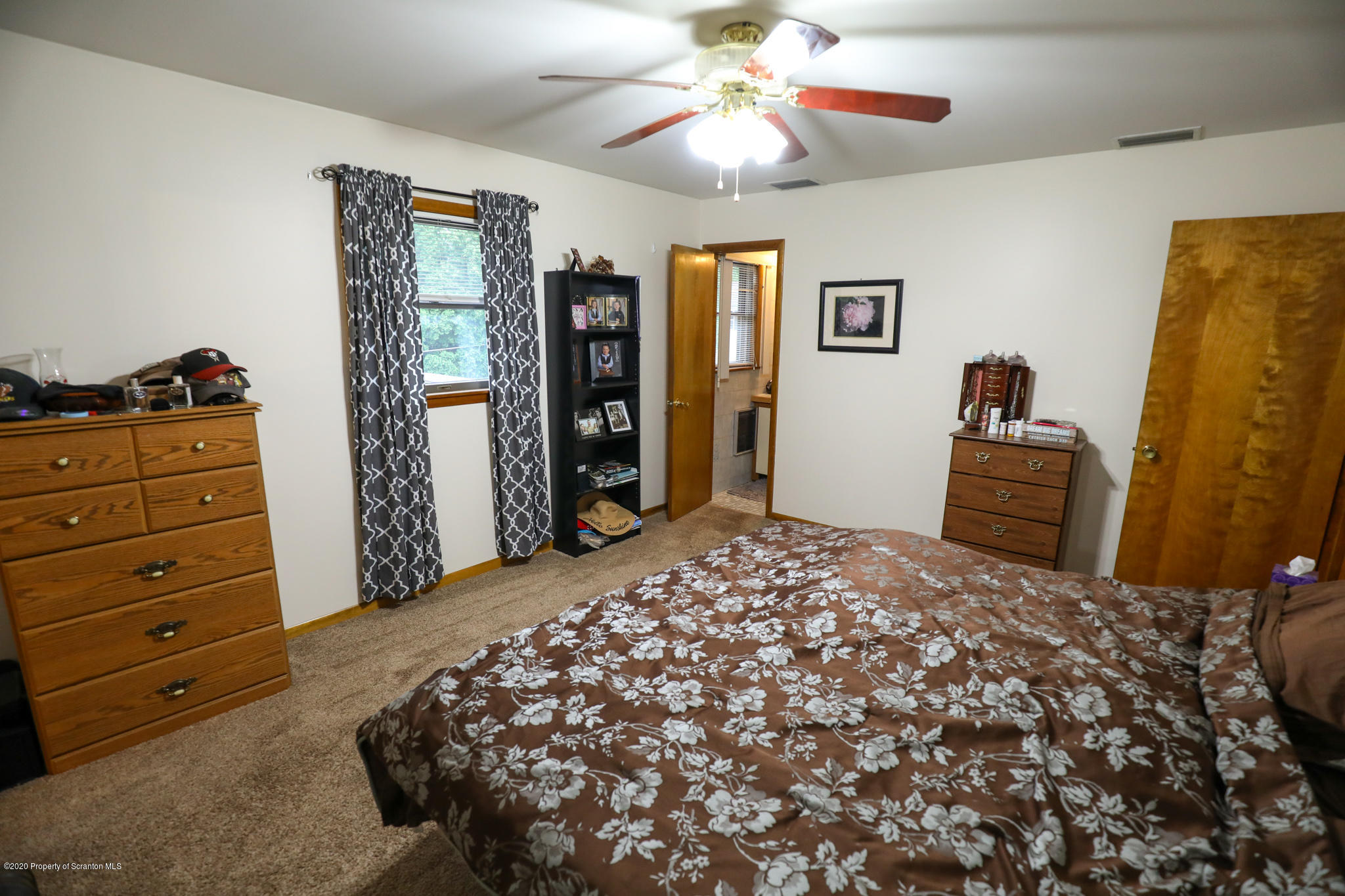 3 Patrick Road Pittston, PA 18640 - Photo 8 of 16 a bedroom with a bed and a chandelier