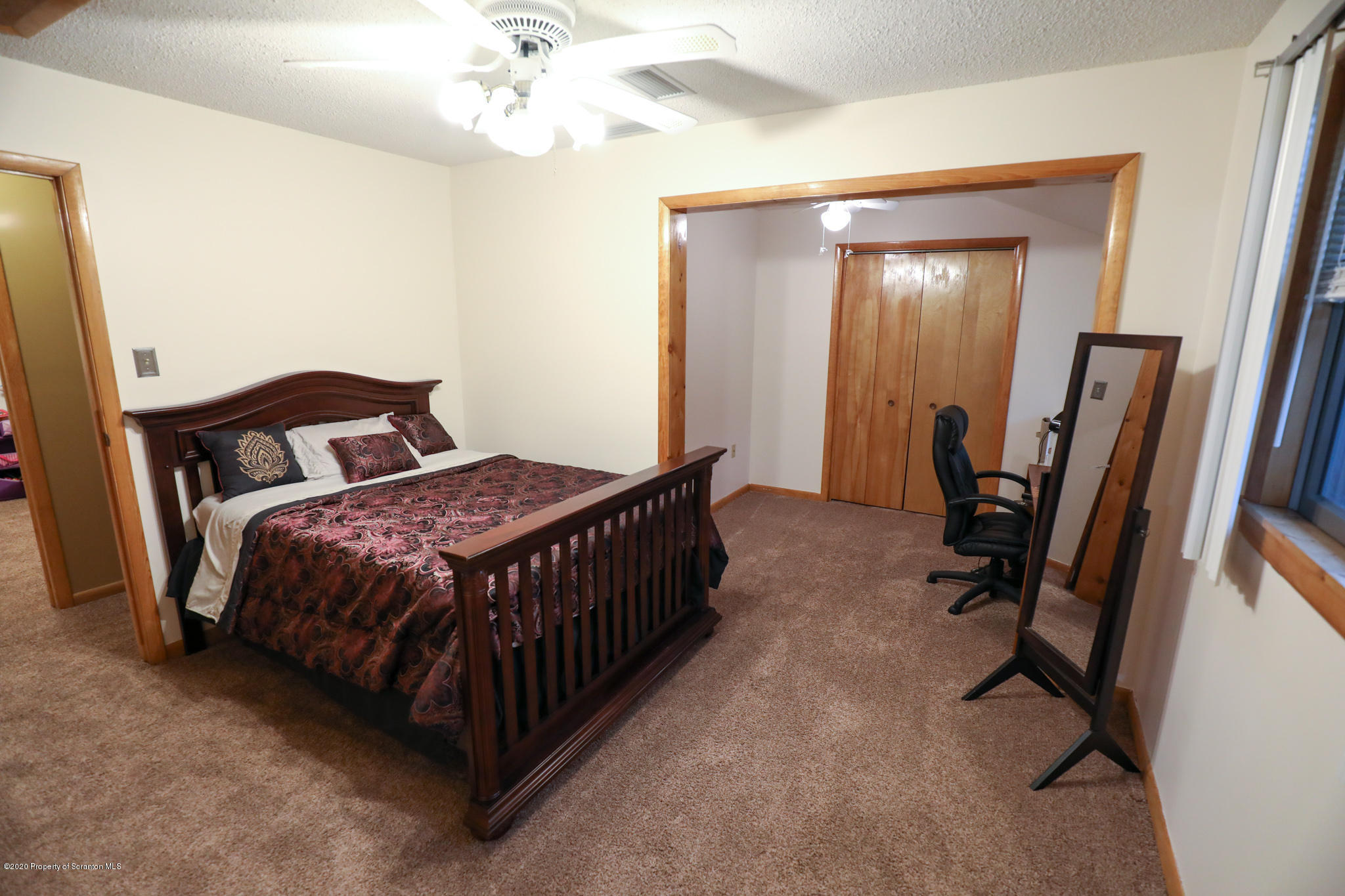 3 Patrick Road Pittston, PA 18640 - Photo 9 of 16 a bedroom with a bed and a chandelier