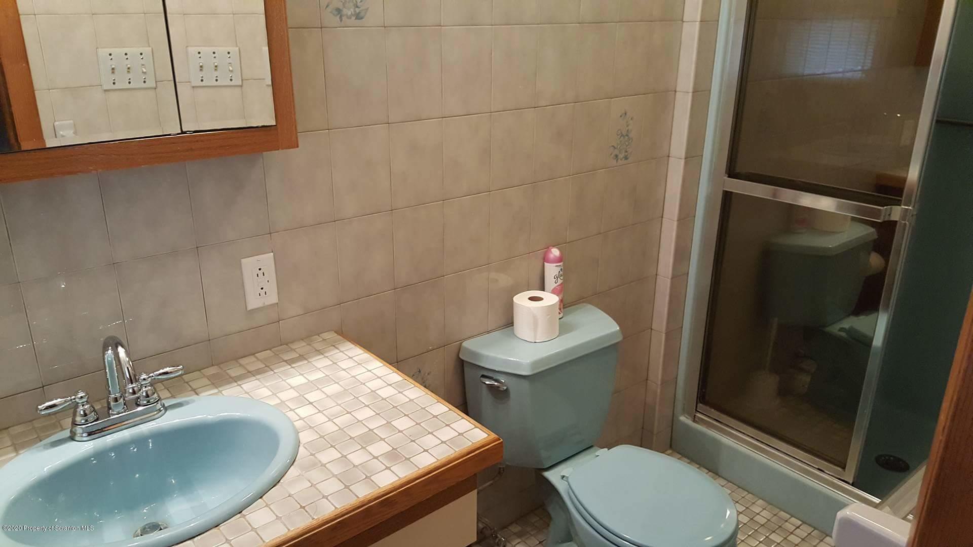 3 Patrick Road Pittston, PA 18640 - Photo 10 of 16 a bathroom with a granite countertop toilet sink and mirror