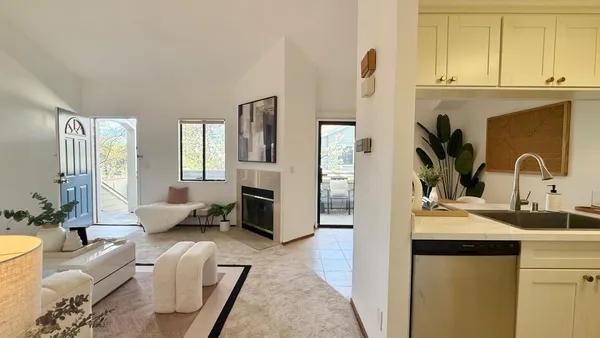 a kitchen with stainless steel appliances granite countertop a sink and a refrigerator