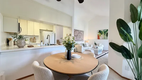 a dining room with furniture and wooden floor