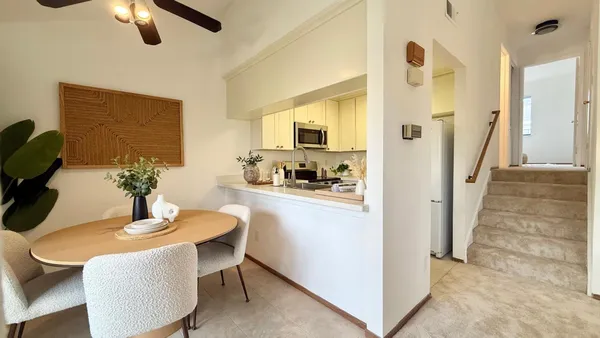 a kitchen with a table and refrigerator