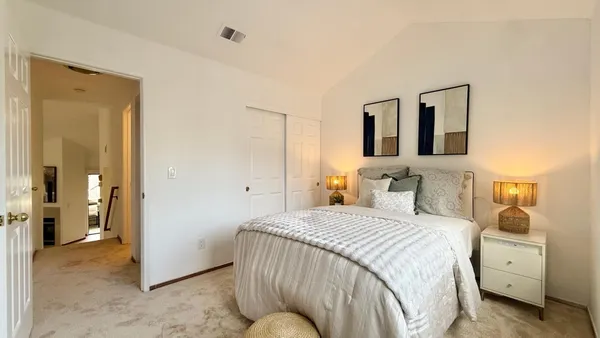 a bedroom with a bed and a couch